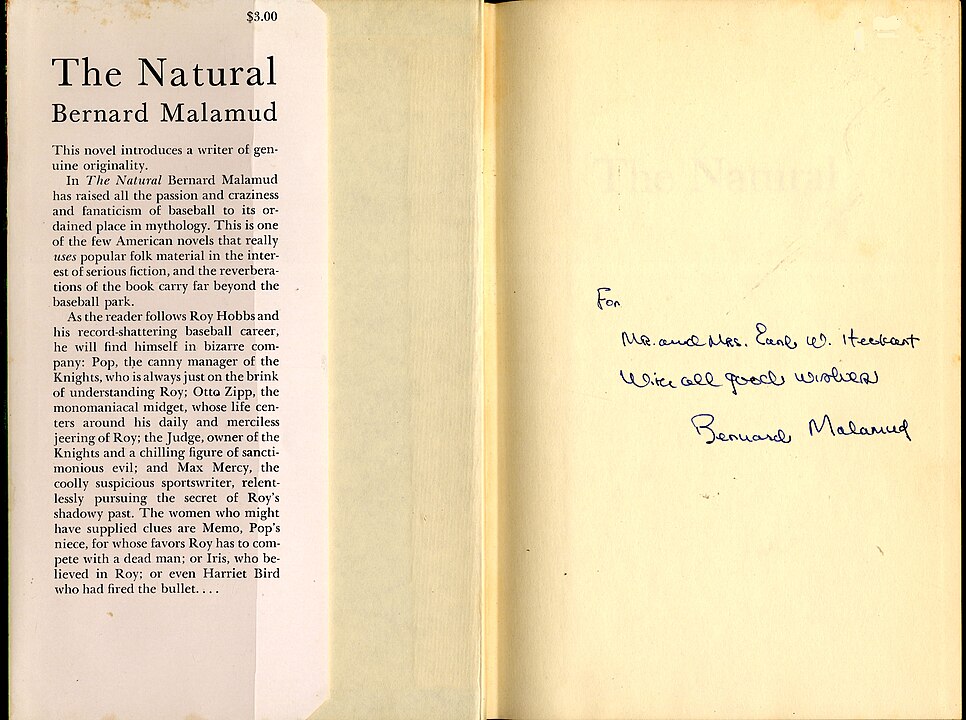 A scan of a book page with an author's signature and note