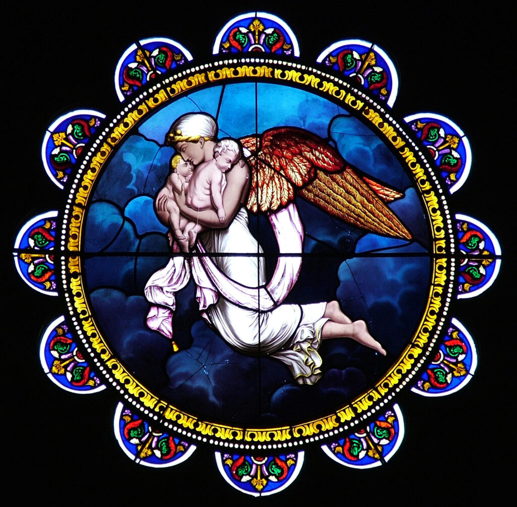 Round stained-glass window with painting of angel holding two sleeping infants in blue clouds