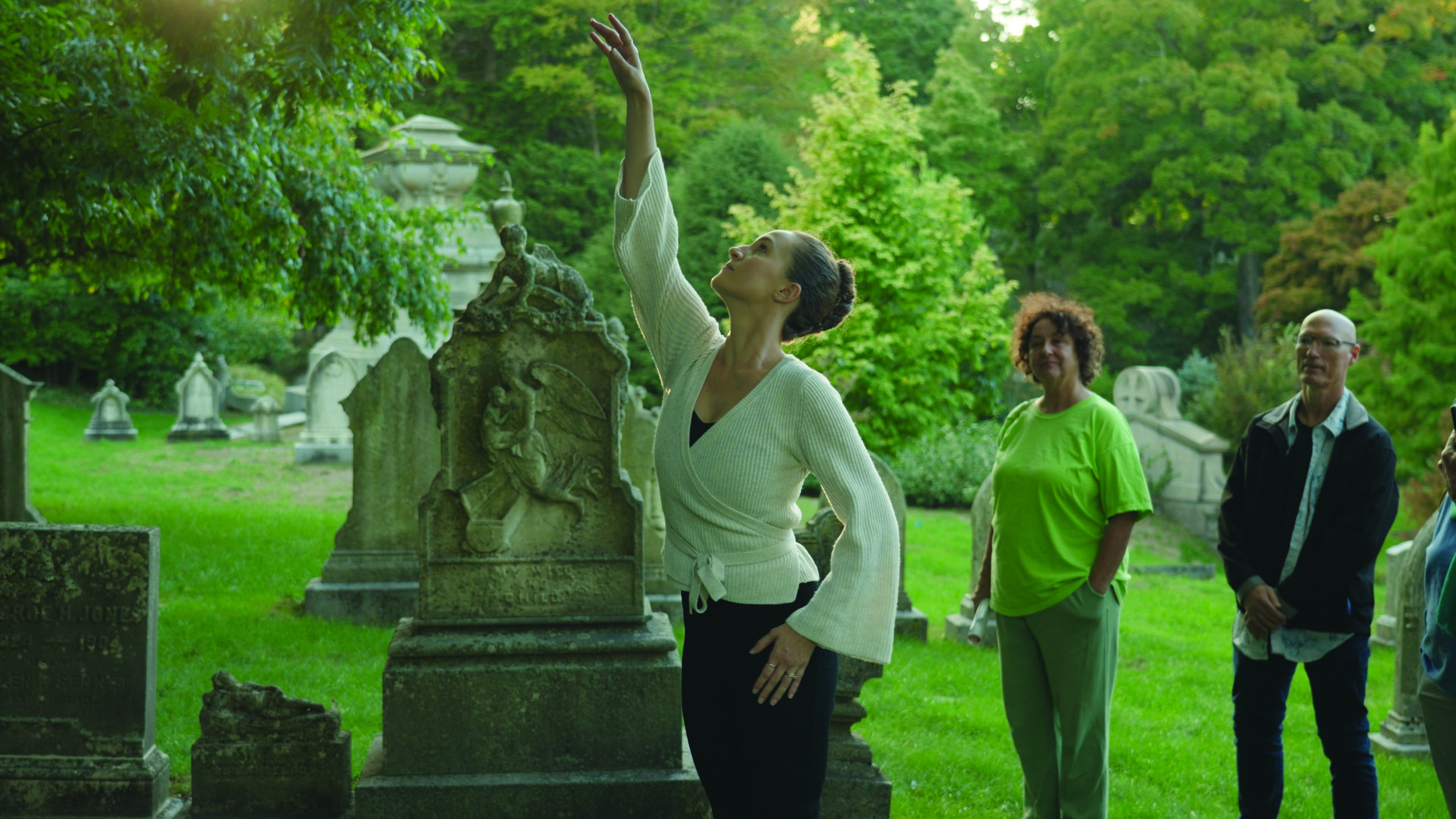 a woman dances in a cemetery